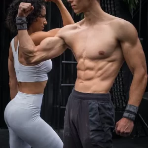 Very fit male and female flexing their bicep muscles