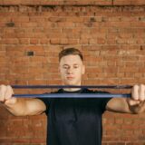 Muscular white male pulling resistance bands